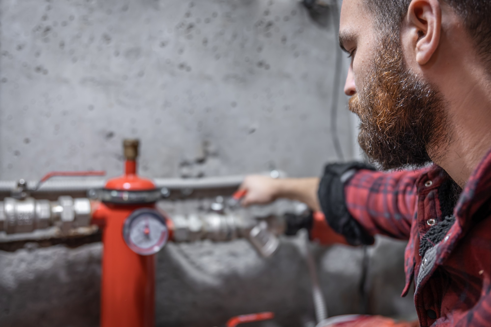 Plumbify technician checking valves and a pressure gauge for hidden leaks